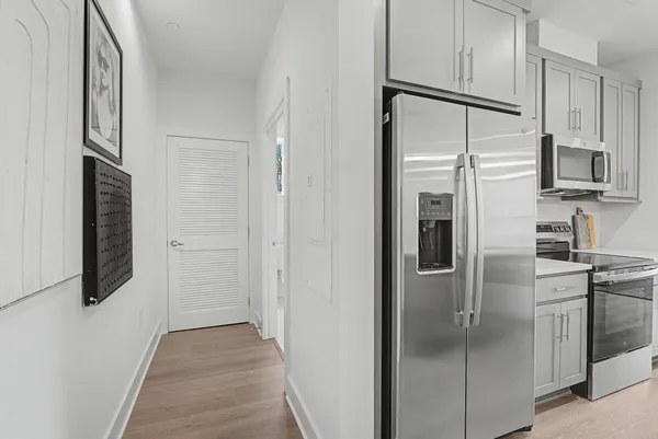 a kitchen with stainless steel appliances a refrigerator and cabinets