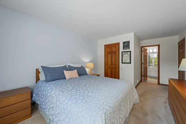 a bedroom with a bed and lamp