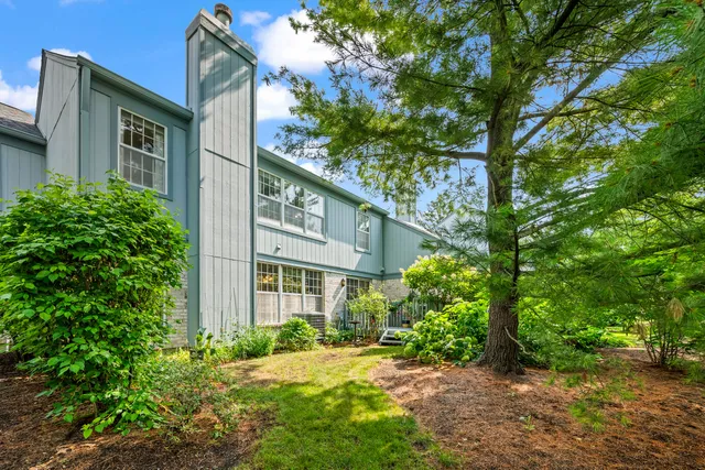 a yellow house with trees in front of it