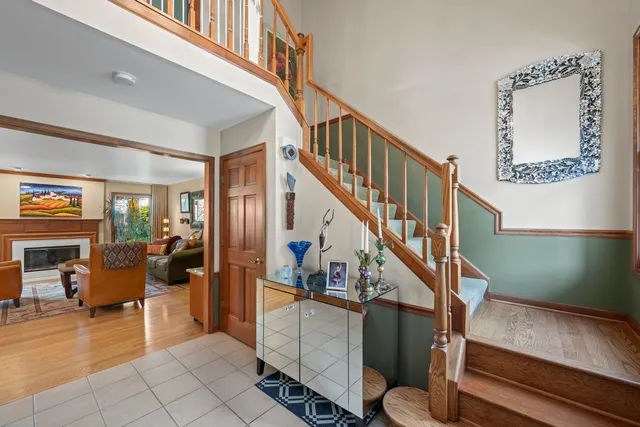 a view of entryway and hall with wooden floor