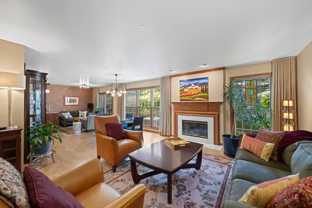 a living room with furniture fireplace and a large window
