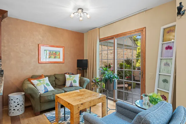 a living room with furniture and a potted plant