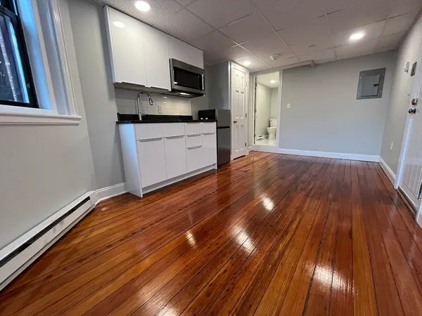 a kitchen with wooden floors and a sink