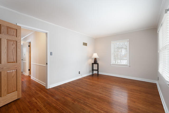 S477 Winfield Road Winfield, IL 60190 - Photo 11 of 29 an empty room with wooden floor and windows