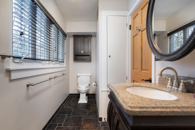 S477 Winfield Road Winfield, IL 60190 - Photo 15 of 29 a bathroom with a granite countertop toilet sink and mirror