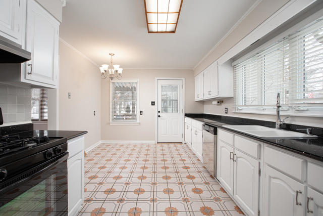 S477 Winfield Road Winfield, IL 60190 - Photo 22 of 29 a kitchen with a sink a stove cabinets and window