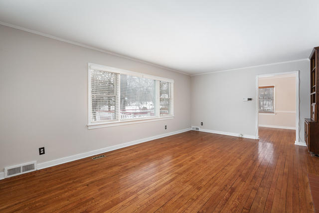 S477 Winfield Road Winfield, IL 60190 - Photo 5 of 29 an empty room with wooden floor and windows