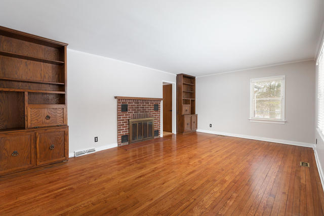 S477 Winfield Road Winfield, IL 60190 - Photo 6 of 29 an empty room with wooden floor cabinet and windows