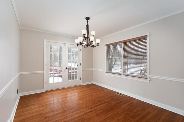 S477 Winfield Road Winfield, IL 60190 - Photo 7 of 29 a view of an empty room with wooden floor and a window