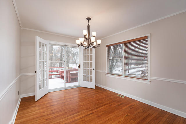 S477 Winfield Road Winfield, IL 60190 - Photo 8 of 29 a view of an empty room with a window and wooden floor