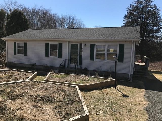 a front view of a house with trees