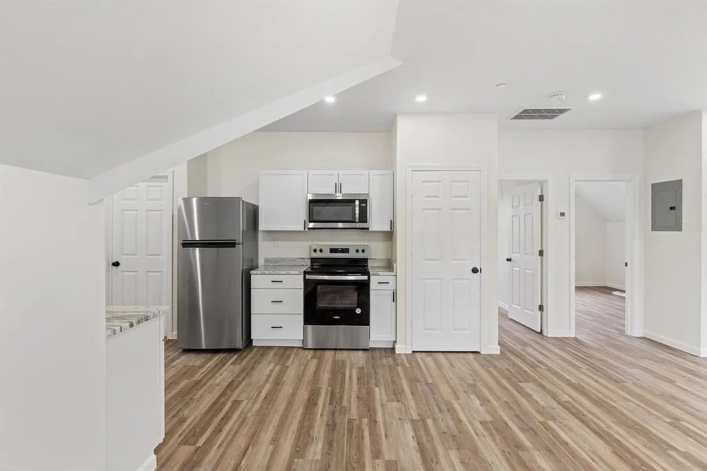 a kitchen with stainless steel appliances a refrigerator and a stove top oven