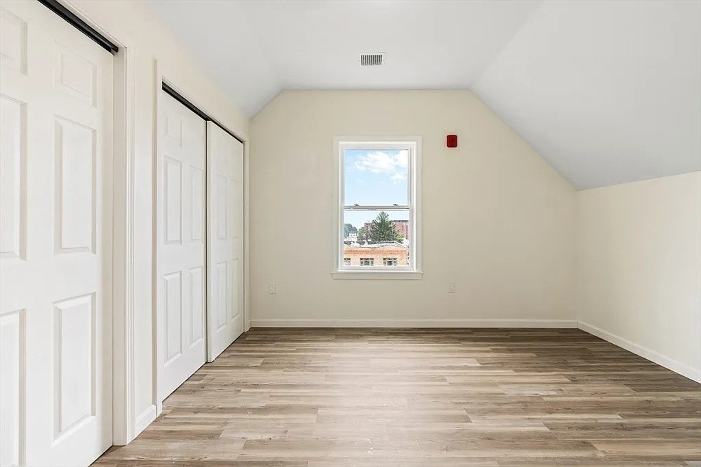 20 Graham Street, Unit 4 Gardner, MA 01440 - Photo 16 of 23 a view of an empty room with wooden floor and a window