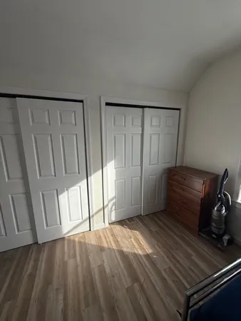 a view of an empty room and wooden floor