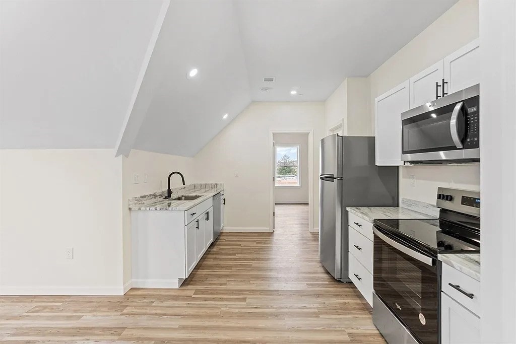 20 Graham Street, Unit 4 Gardner, MA 01440 - Photo 7 of 23 a kitchen with stainless steel appliances a refrigerator stove and microwave