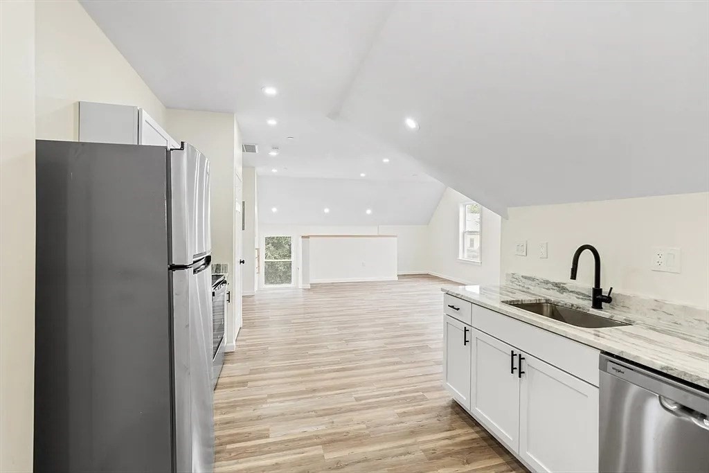 20 Graham Street, Unit 4 Gardner, MA 01440 - Photo 8 of 23 a kitchen with a sink refrigerator and cabinets
