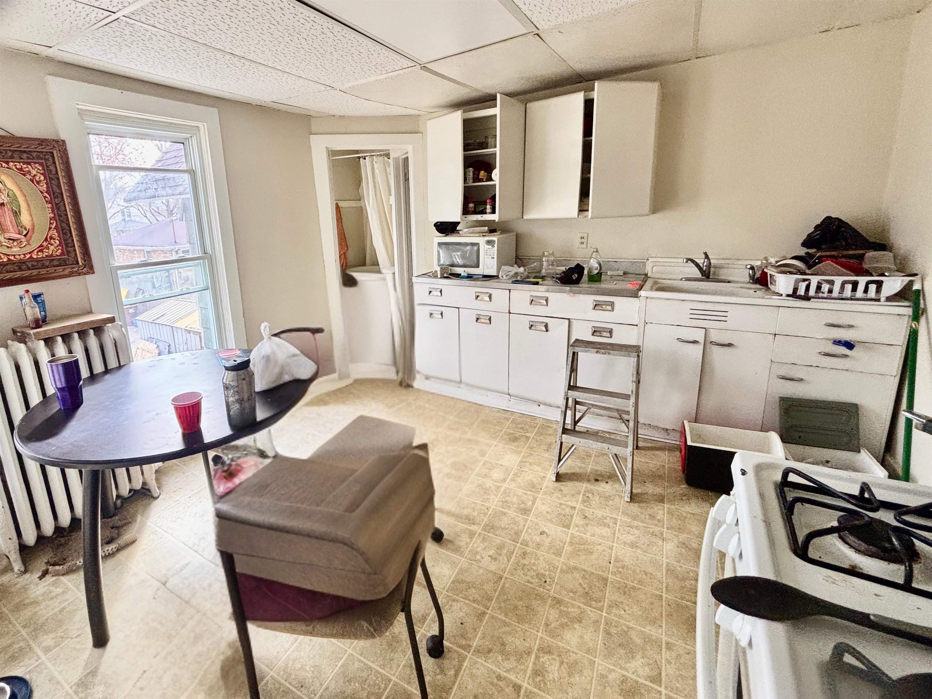 1016 South Main Street Belvidere, IL 61008 - Photo 5 of 17 a living room with furniture a flat screen tv and a table
