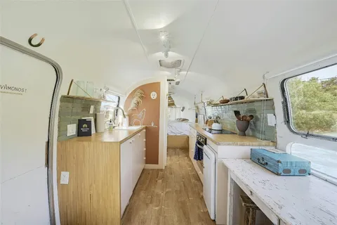 a view of a kitchen with kitchen island wooden floor center island and stainless steel appliances