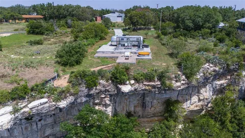 an aerial view of a house with outdoor space swimming pool and mountains