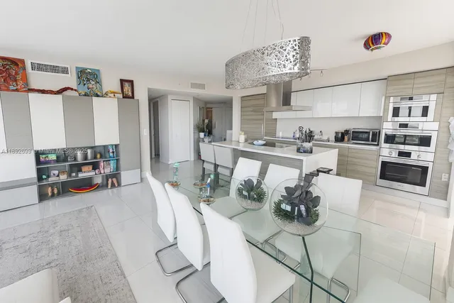 a kitchen with stainless steel appliances kitchen island granite countertop a stove and cabinets