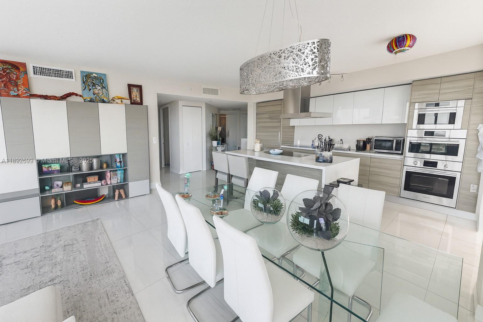 300 Sunny Isles Boulevard, Unit 42407 Sunny Isles Beach, FL 33160 - Photo 4 of 6 a kitchen with stainless steel appliances kitchen island granite countertop a stove and cabinets