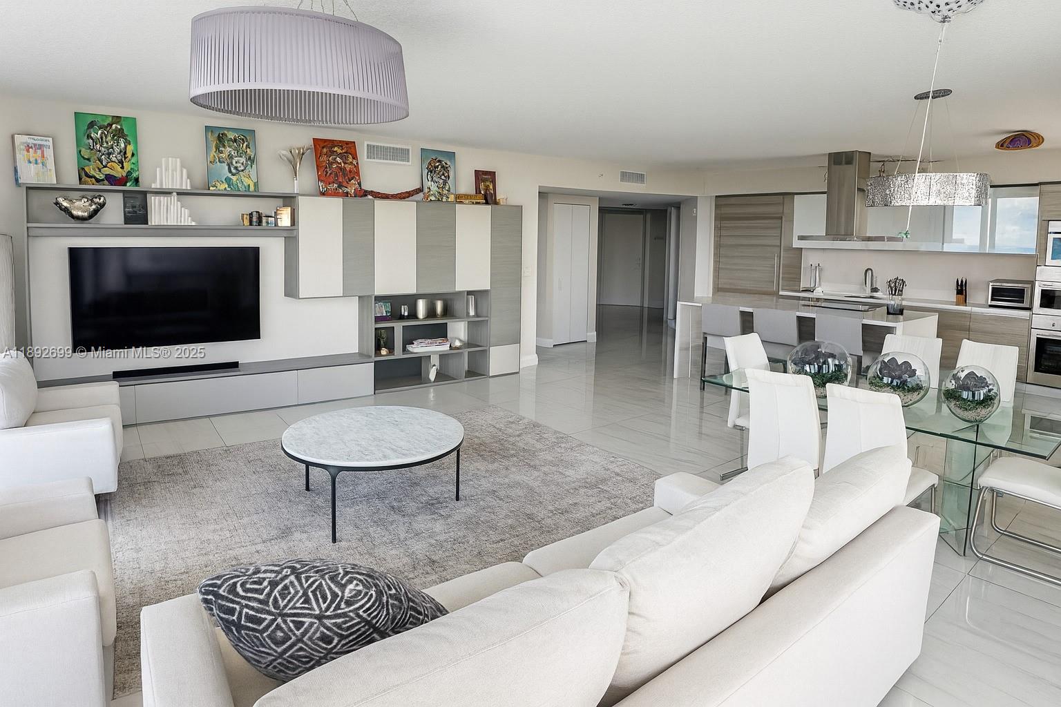 300 Sunny Isles Boulevard, Unit 42407 Sunny Isles Beach, FL 33160 - Photo 6 of 6 a living room with furniture and a flat screen tv