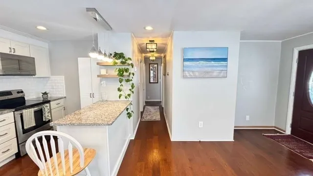 a kitchen with a refrigerator and a stove top oven