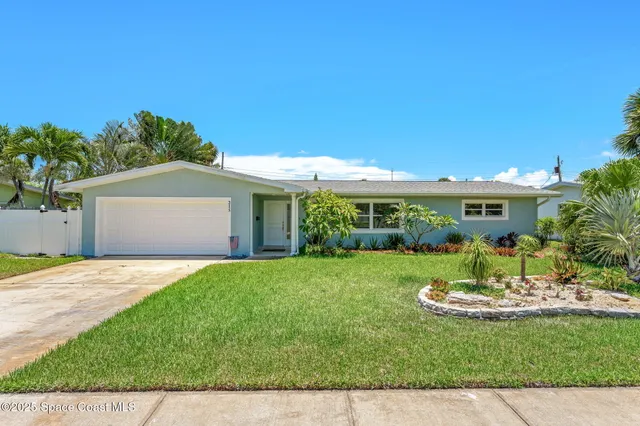 a front view of a house with a yard and table and chairs