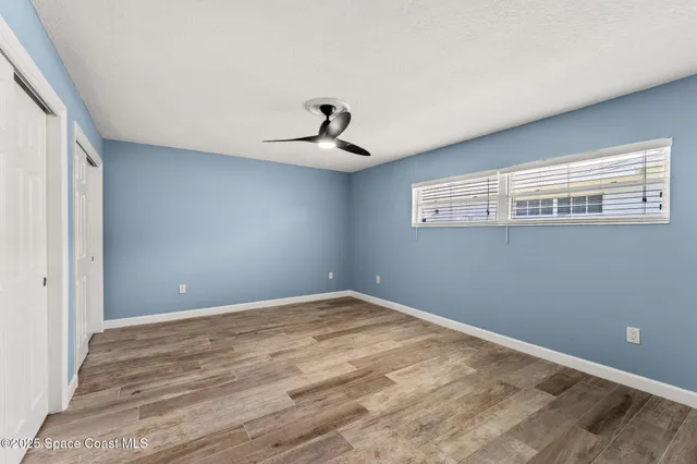 a view of a livingroom with a chandelier fan