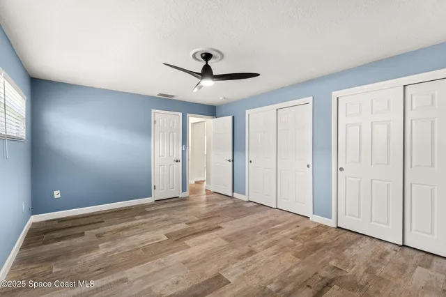 a bathroom with a granite countertop toilet a sink and a mirror