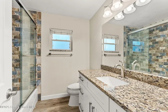 an empty room with window and ceiling fan