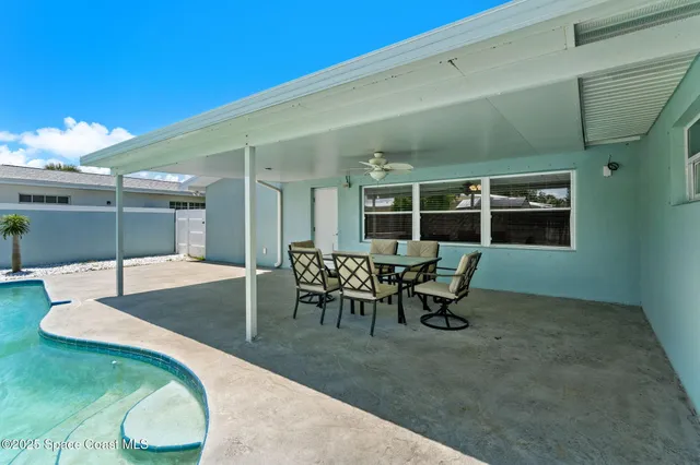 a view of a house with backyard and porch