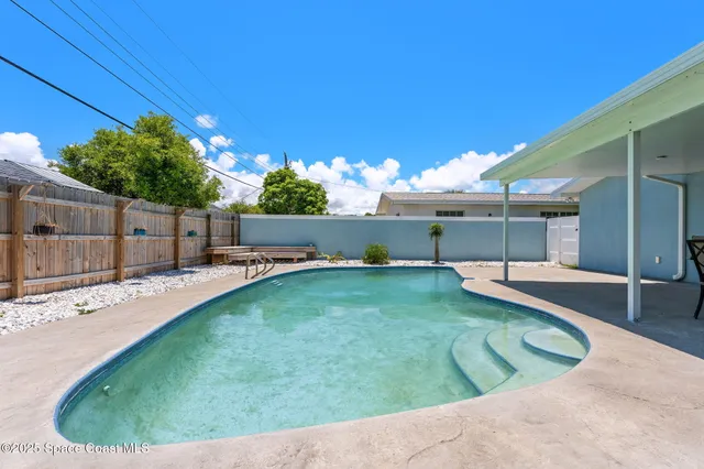 a front view of a house with a garden and yard