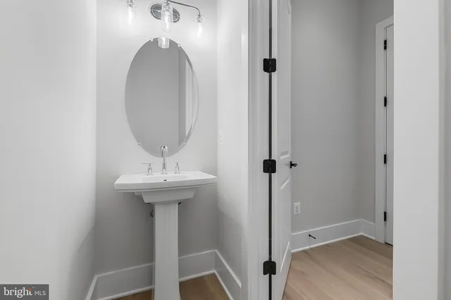 a bathroom with a toilet a sink and mirror