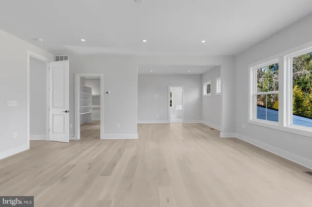 a bathroom with a granite countertop sink and mirror with bathtub