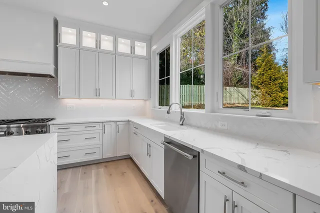 a kitchen with a sink and large window