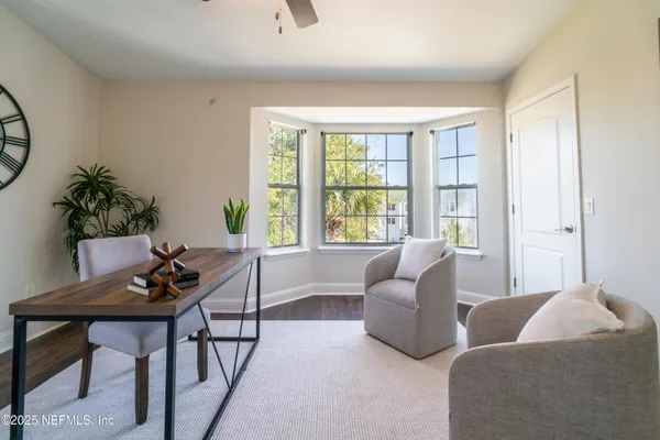 a spacious bedroom with a bed a window and a chandelier
