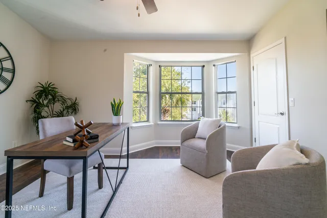 a spacious bedroom with a bed a window and a chandelier