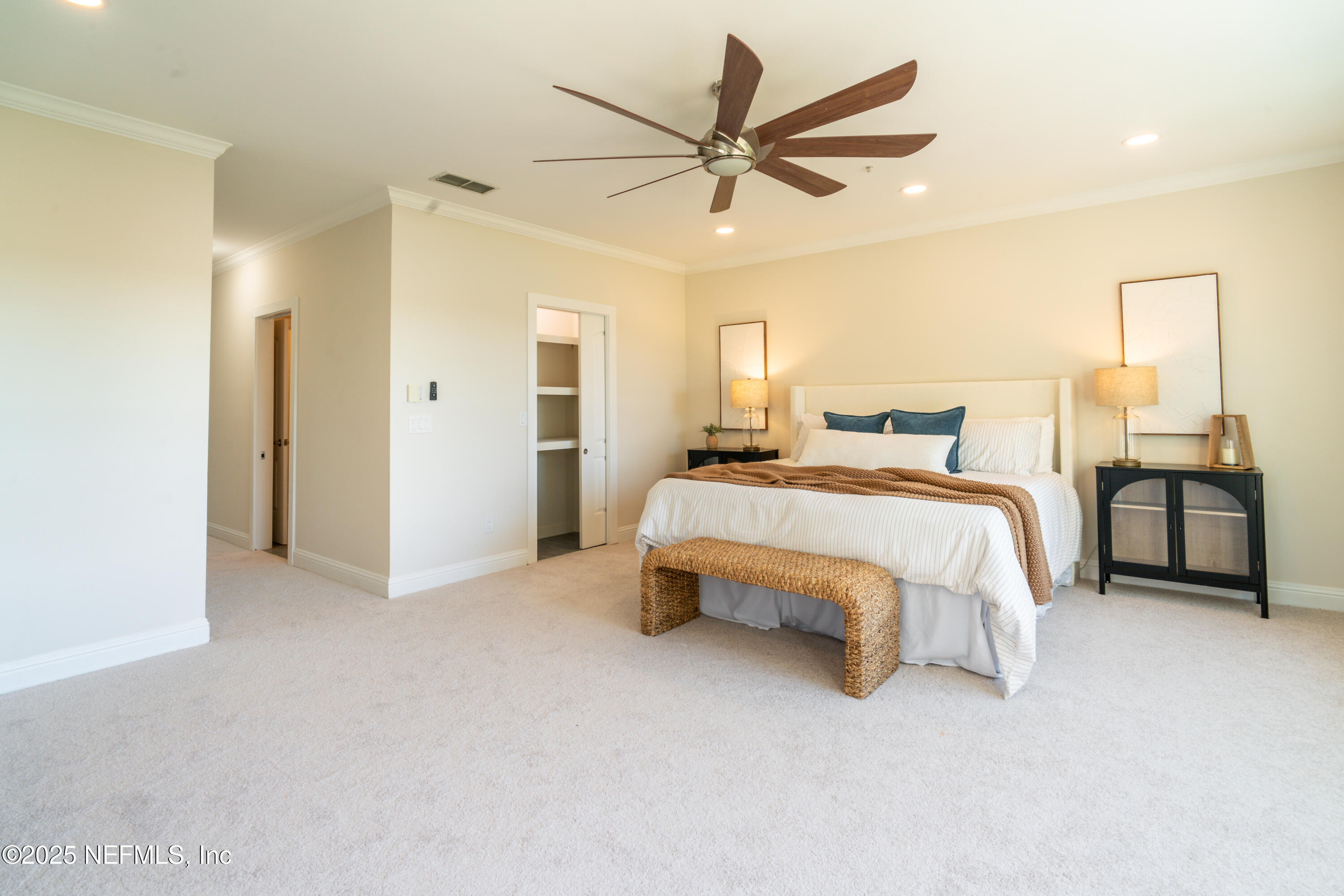 3360 Lighthouse Point Lane Jacksonville, FL 32250 - Photo 21 of 65 a bedroom with a bed and a chandelier