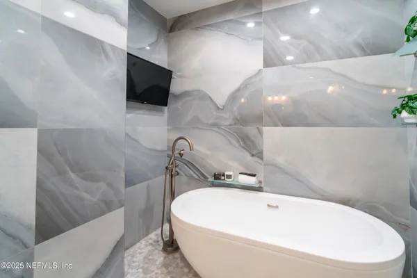 a bathroom with a granite countertop sink a mirror and a shower