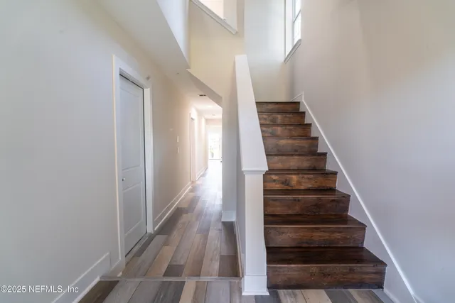 a living room with furniture potted plant and a table