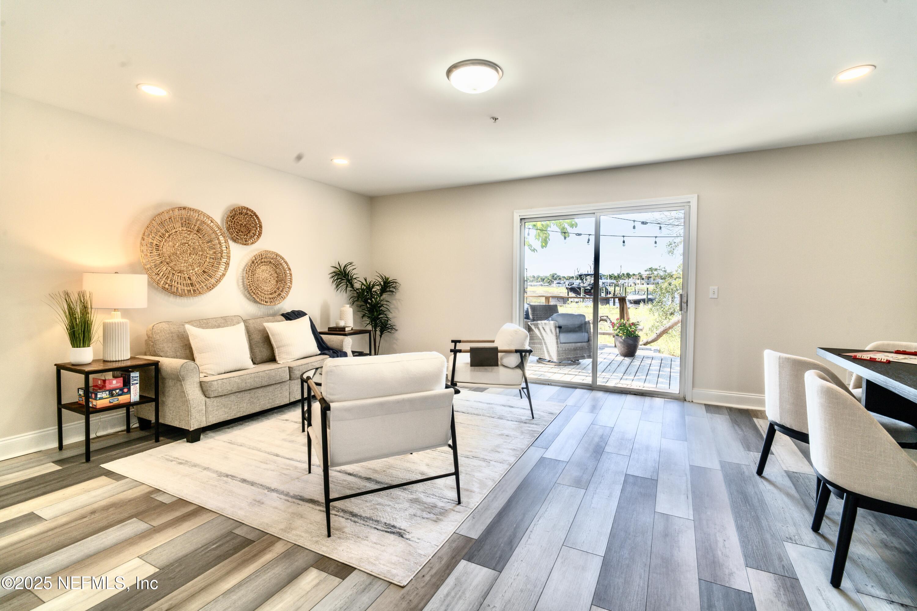 3360 Lighthouse Point Lane Jacksonville, FL 32250 - Photo 40 of 65 a living room with furniture and a wooden floor