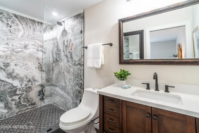 a view of a terrace with chairs and a lake view