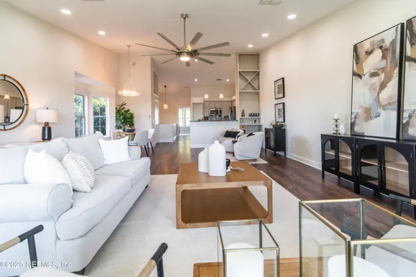 a living room with furniture and painting on the wall