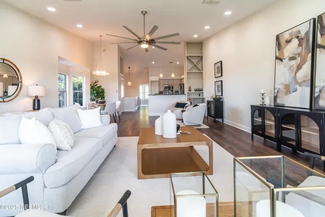a living room with furniture and painting on the wall