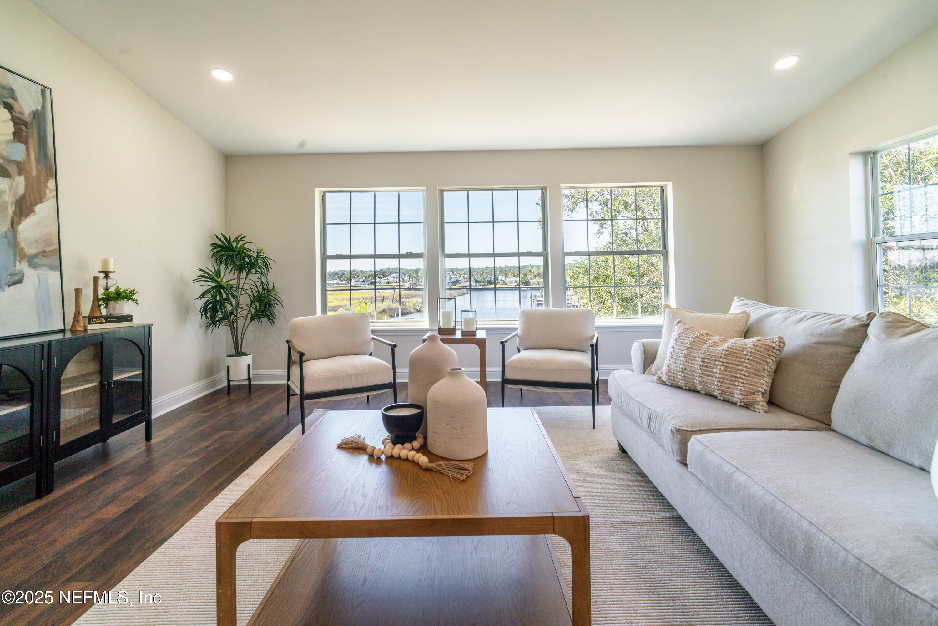 3360 Lighthouse Point Lane Jacksonville, FL 32250 - Photo 6 of 65 a living room with furniture large window and a table