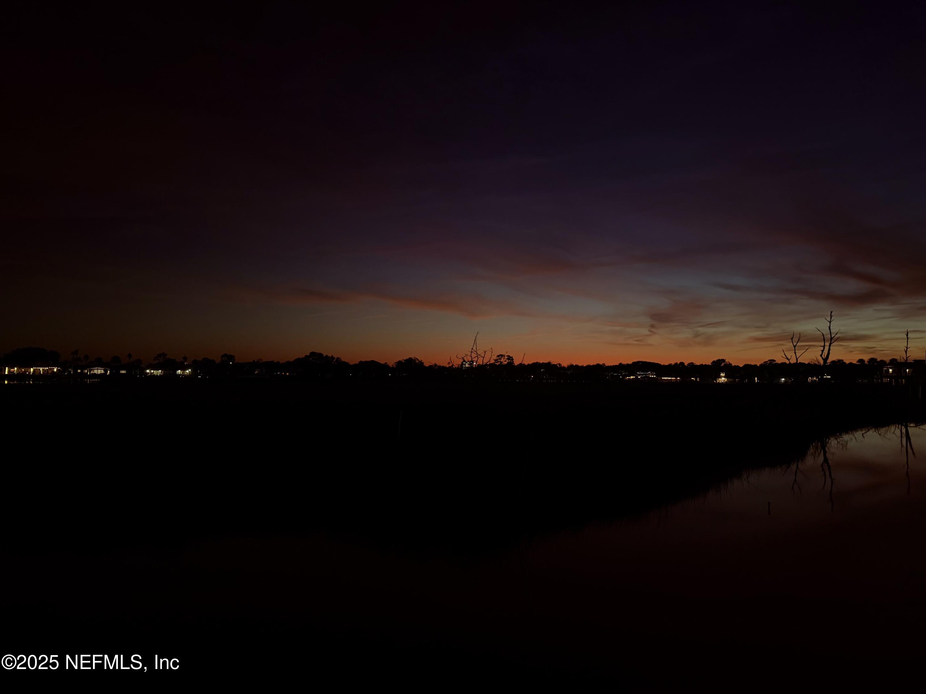 3360 Lighthouse Point Lane Jacksonville, FL 32250 - Photo 64 of 65 a view of a lake with a mountain