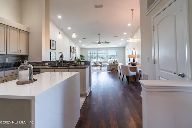 a kitchen with sink refrigerator and microwave