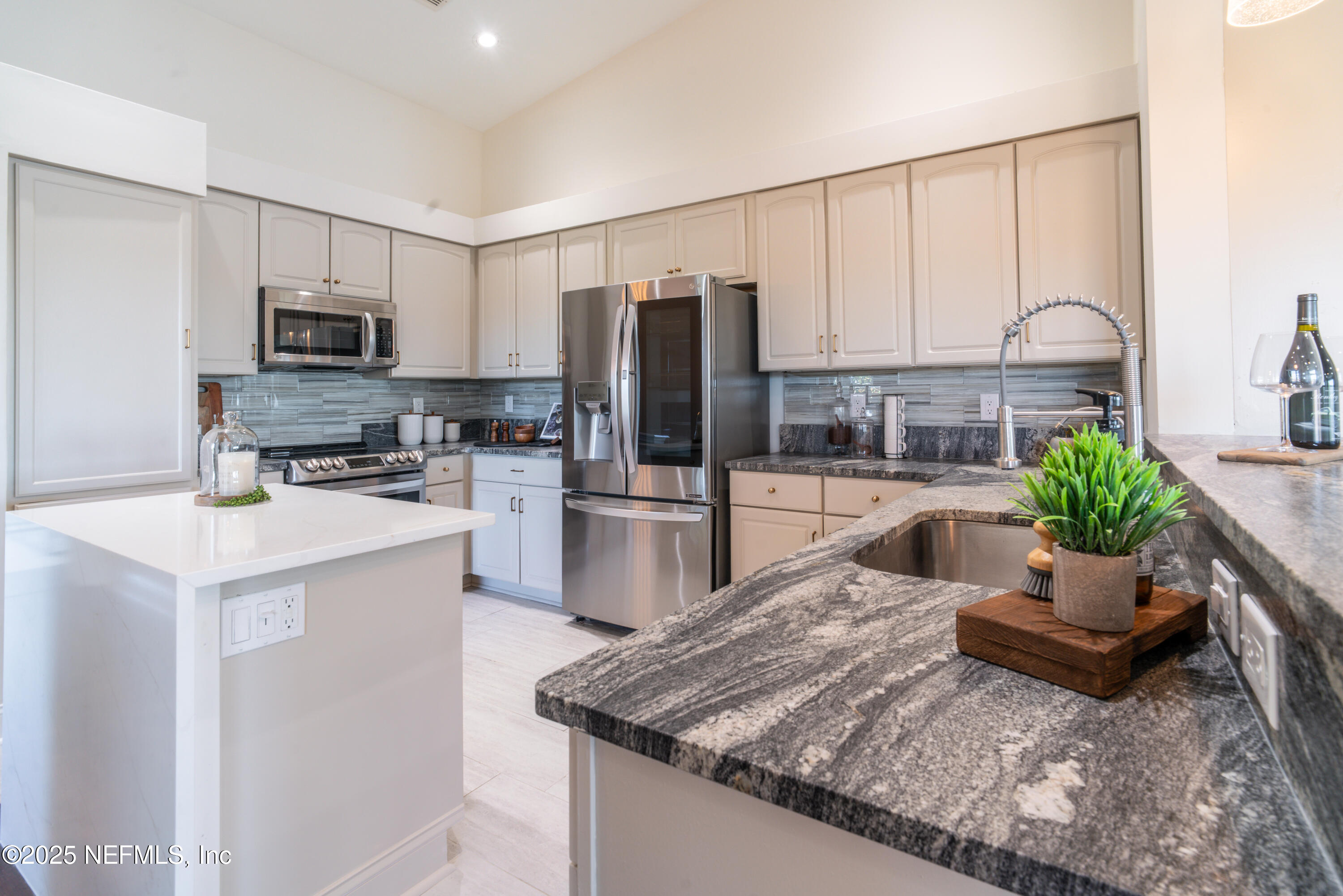3360 Lighthouse Point Lane Jacksonville, FL 32250 - Photo 10 of 65 a kitchen with sink refrigerator and microwave