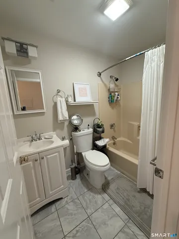 a bathroom with a toilet sink and a mirror
